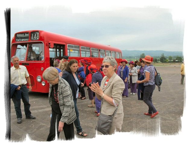 Our passengers leaving the bus at Cheltenham racecourse Station, including 12 ladies in Red Hats!