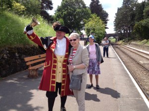 Pam with the Town Crier at Cheltenham Racecourse station